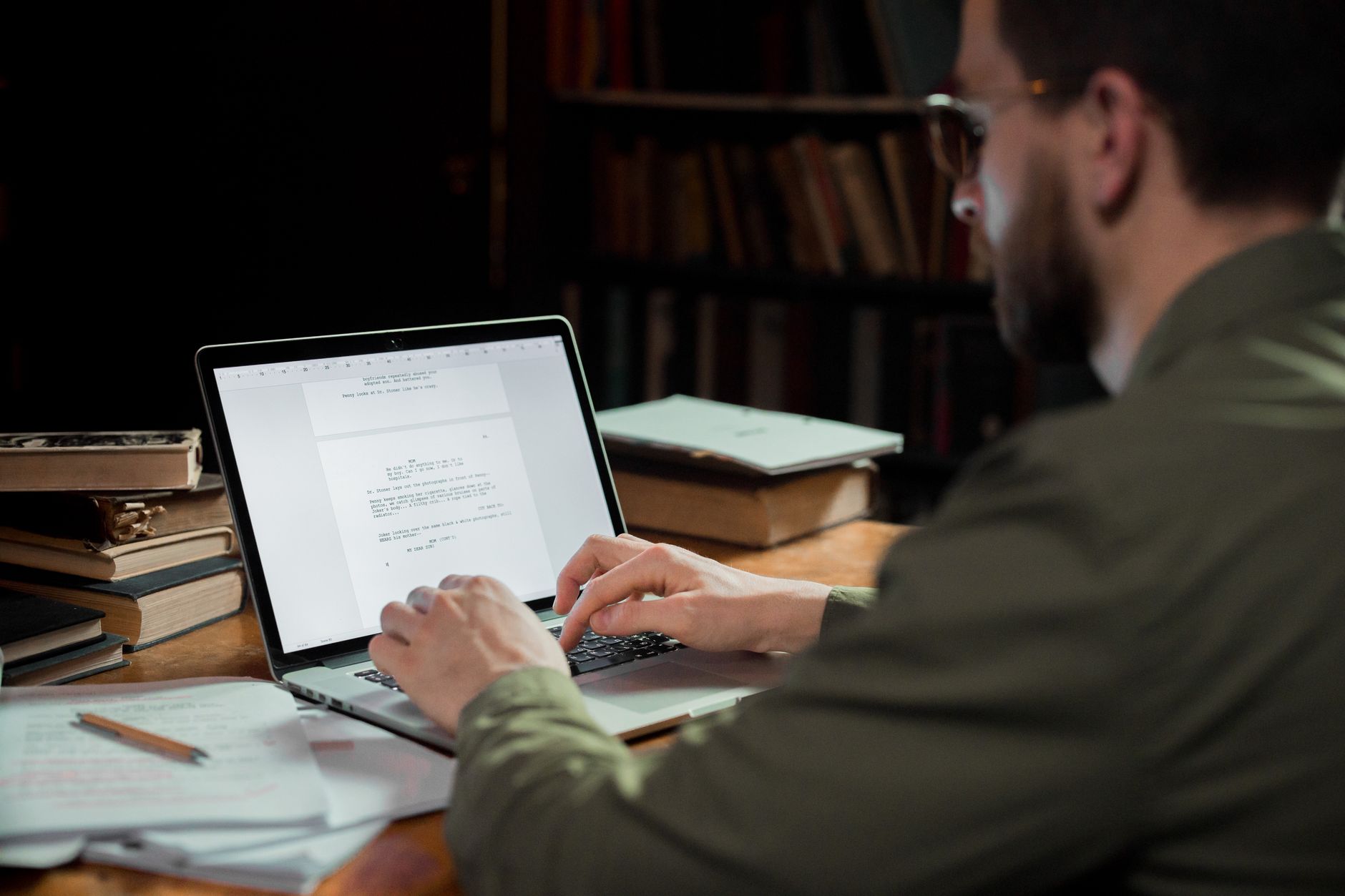 Person reading discussion threads on a laptop at a desk.