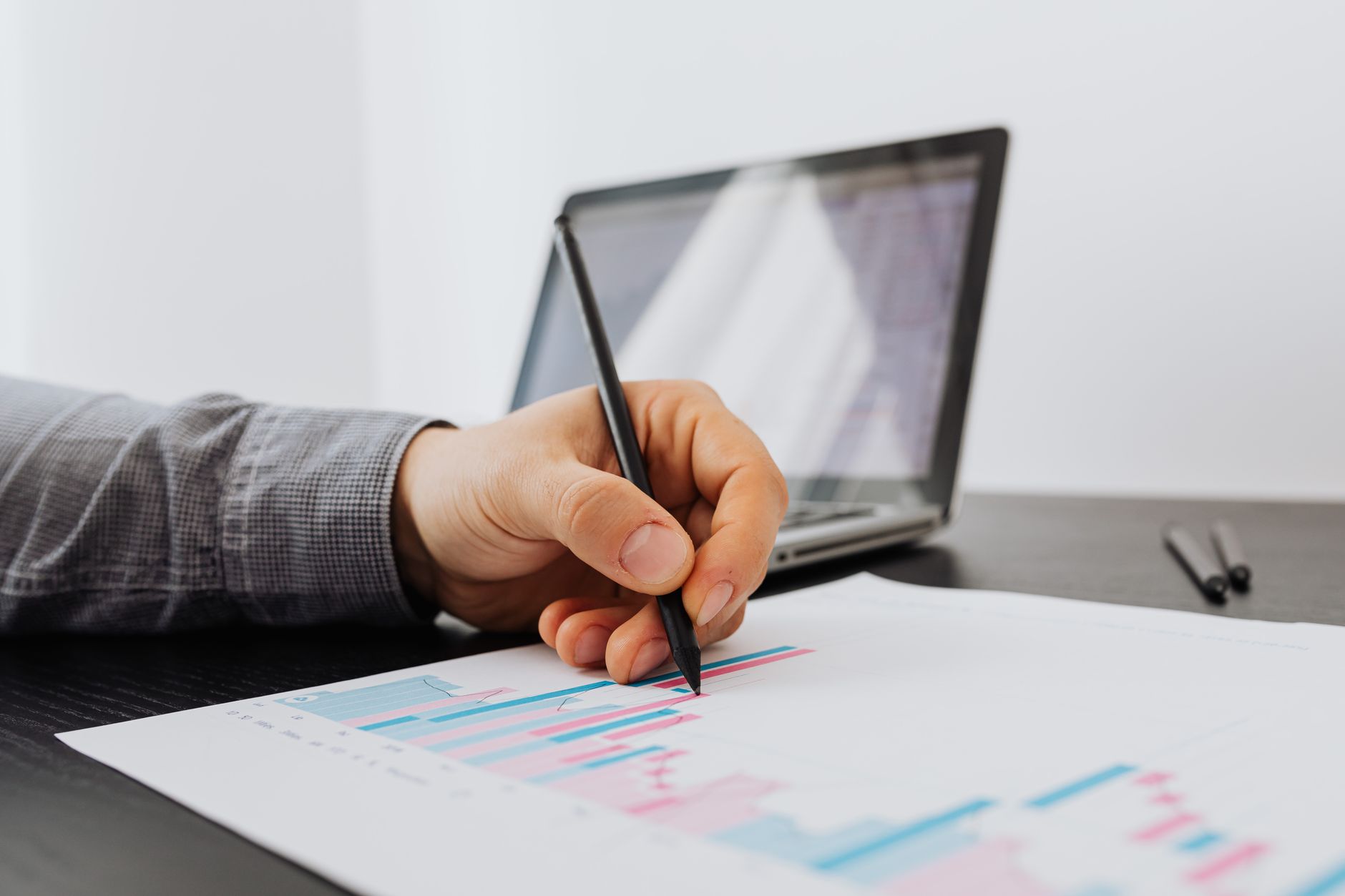 Founder reviewing a marketing report with charts and notes.