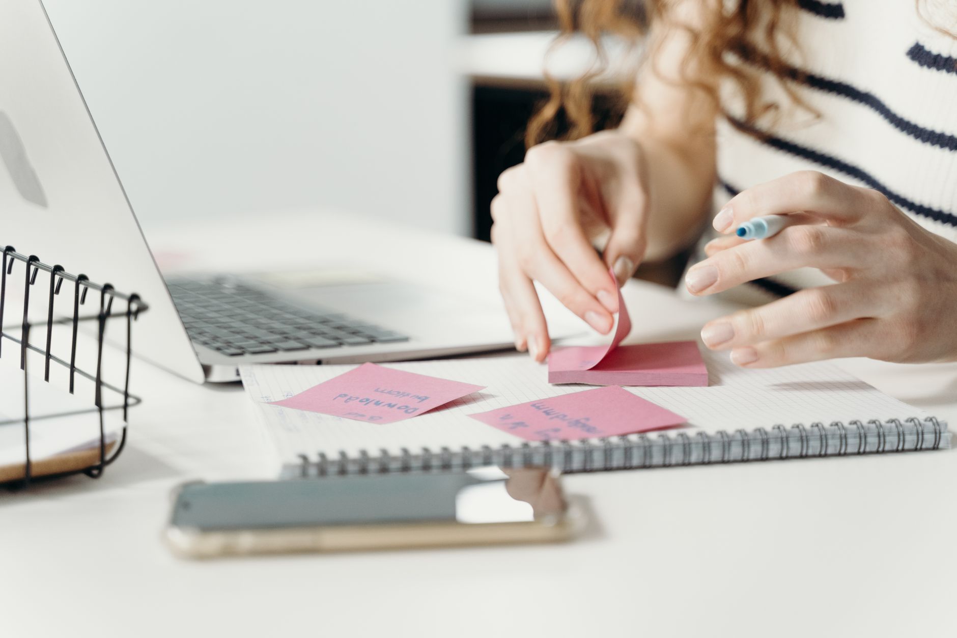 Creator arranging notes and printed stills to plan videos
