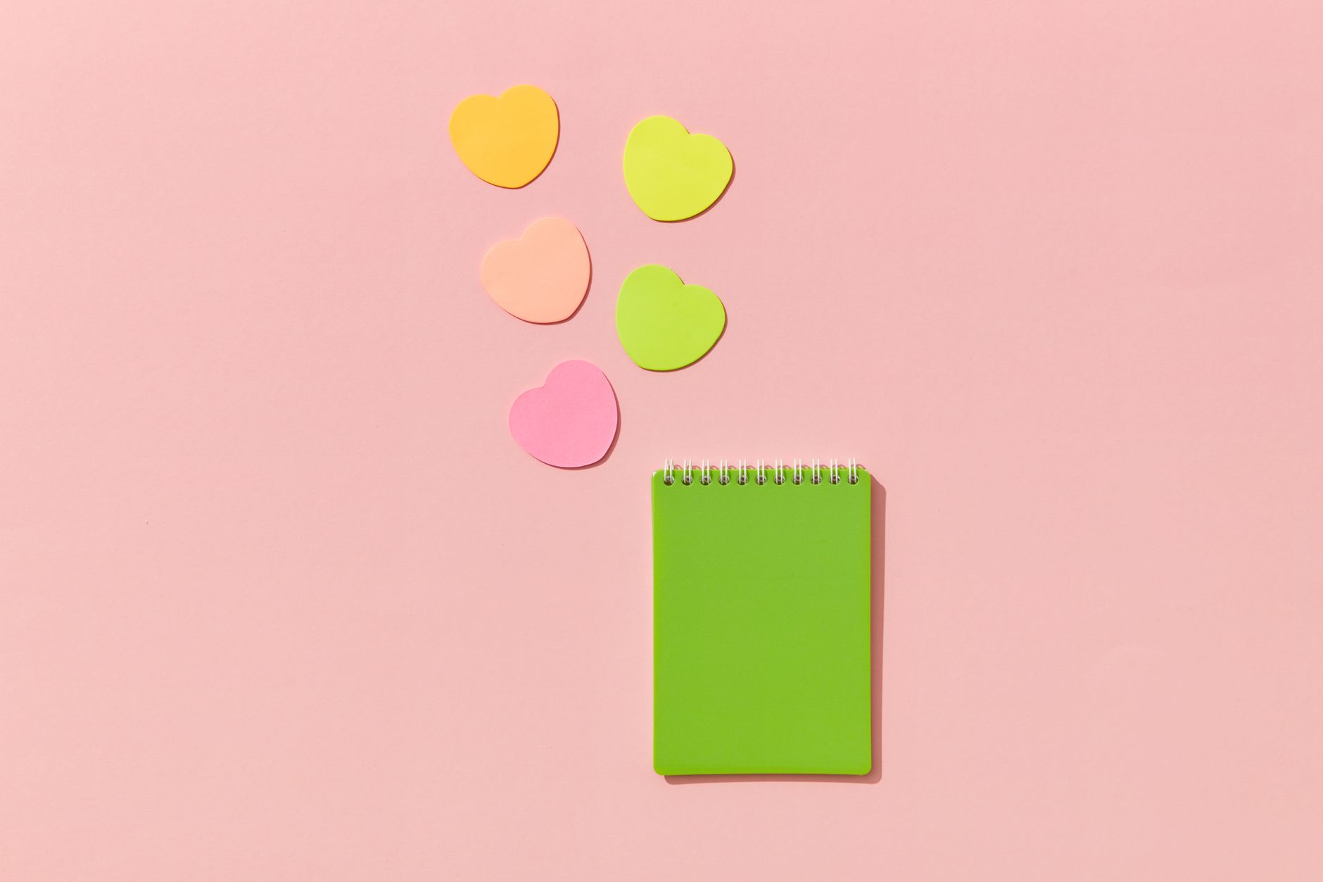 An open notebook surrounded by cards and sticky notes