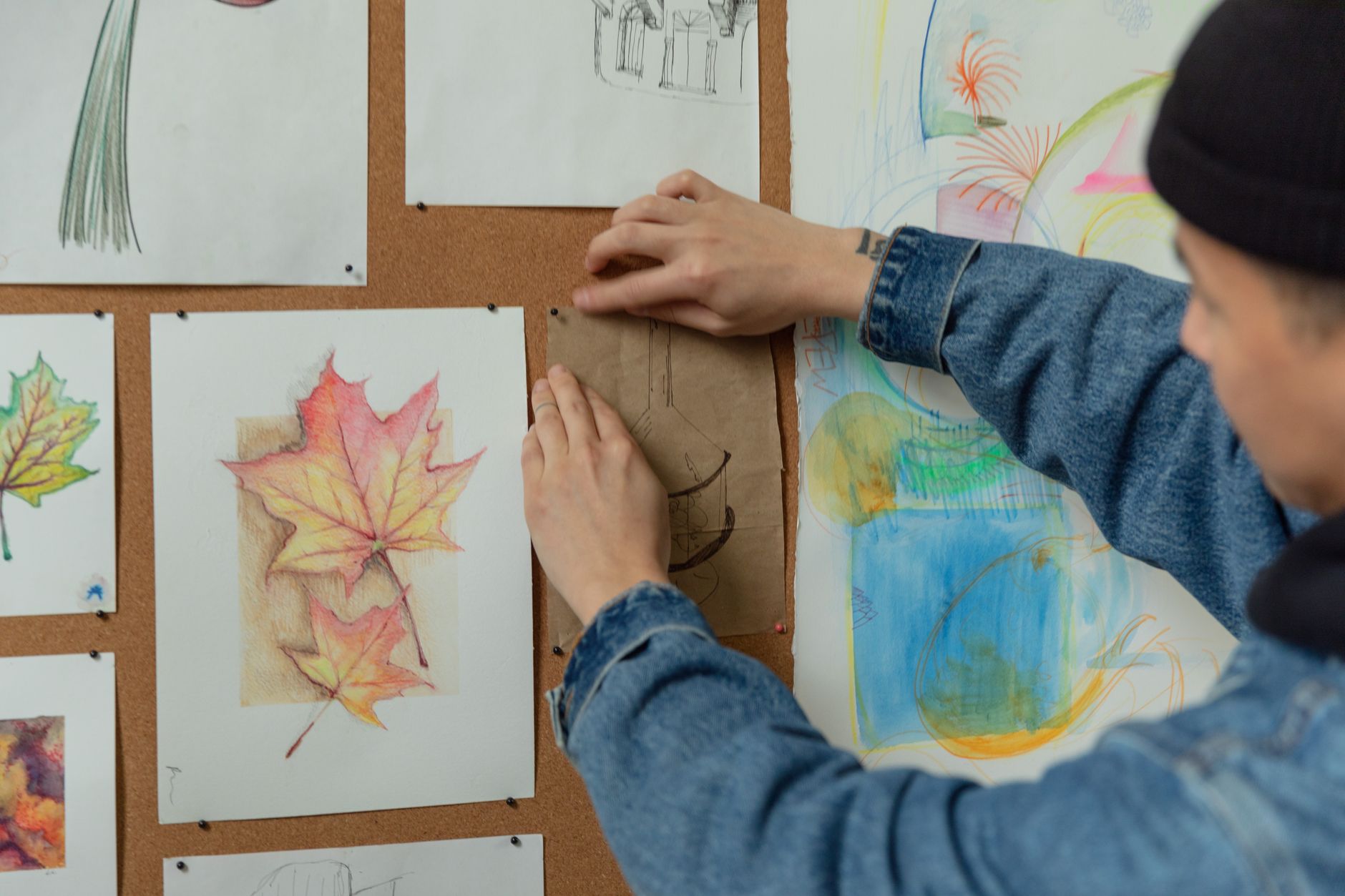 Illustration of a creator organizing reference images on a corkboard